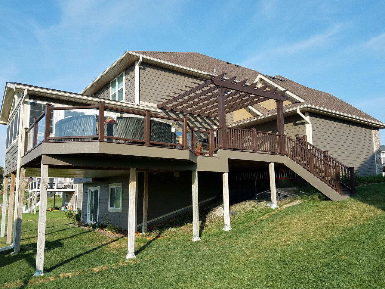 Home addition with raised deck and pergola by BN Builders