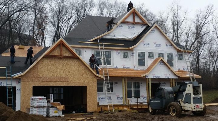 A team of builders on an ongoing house construction