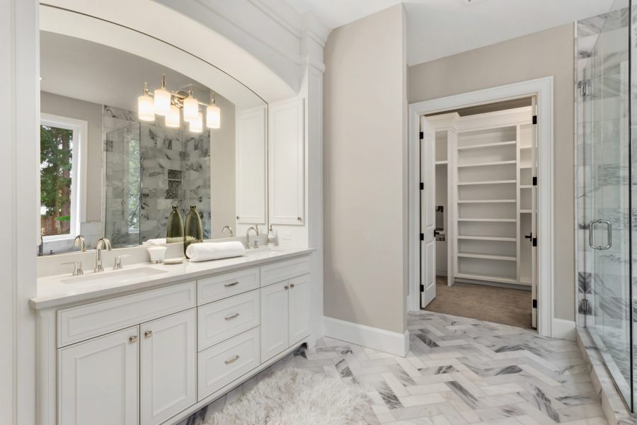Sophisticated bathroom interior connected to a walk-in closet of a luxurious room