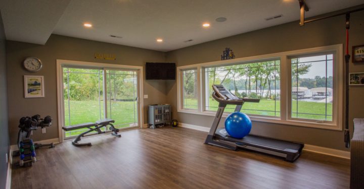 A fitness room with treadmill and other fitness equipment